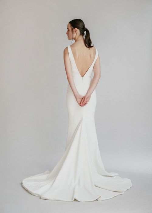 A gorgeous simple v-neck fit and flare gown, with a centre front slit and deep V back - full body back view