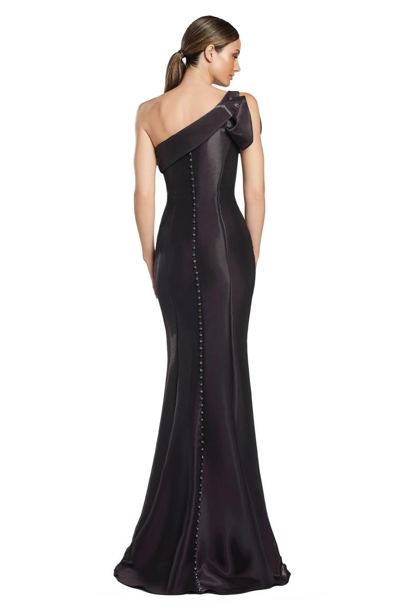 Black one-shoulder evening gown with button details on a white background