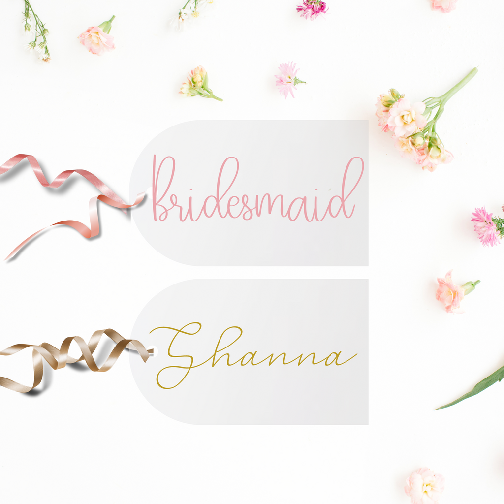 2 acrylic tags, one with "bridesmaid" in pink and the other with "Shanna" in gold