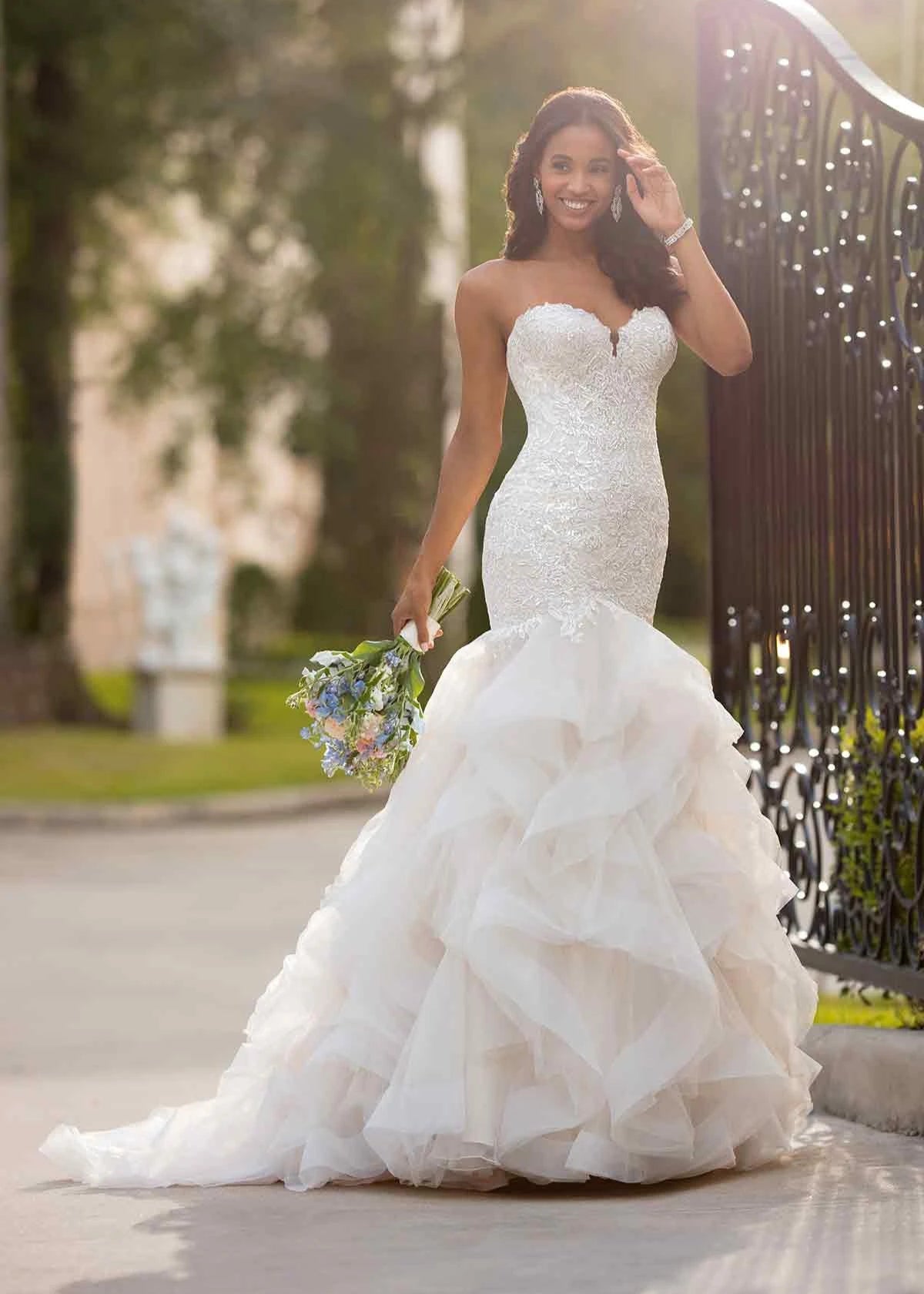 Young woman wearing a large mermaid lace and beaded wedding dress