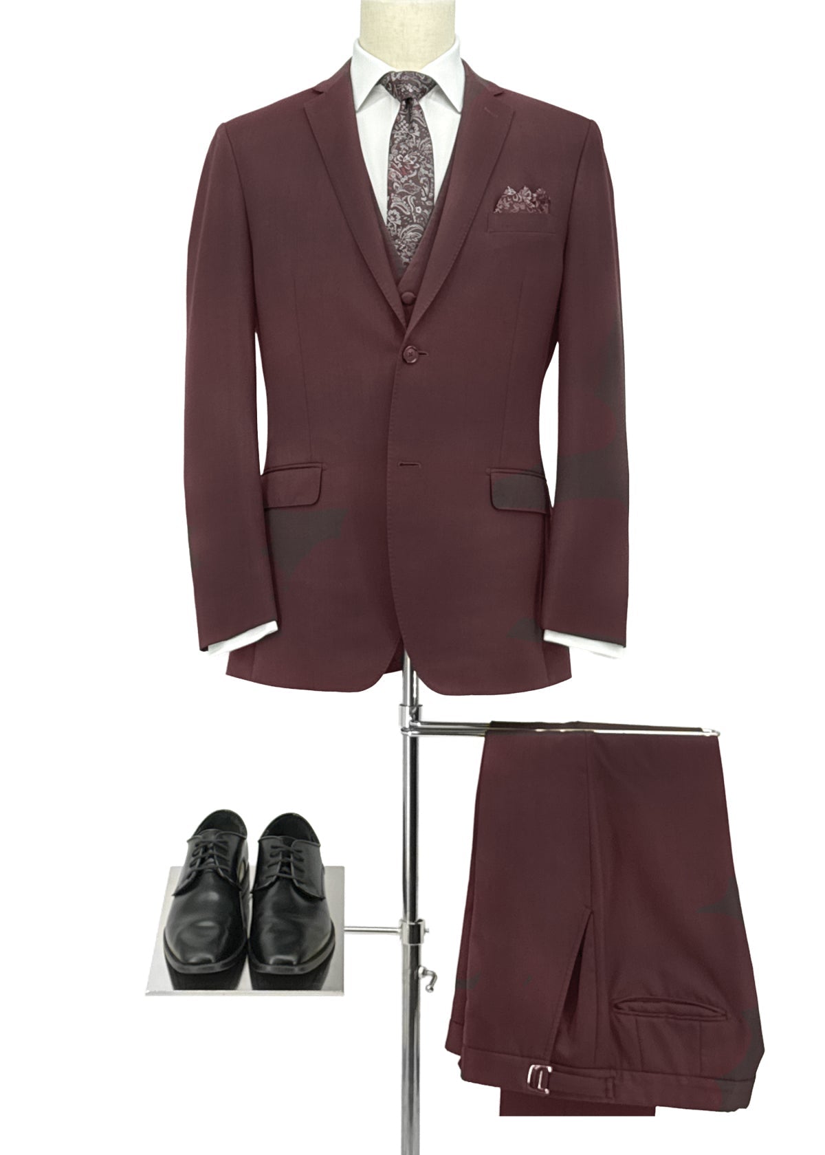 Maroon suit with tie and shoes on a white background