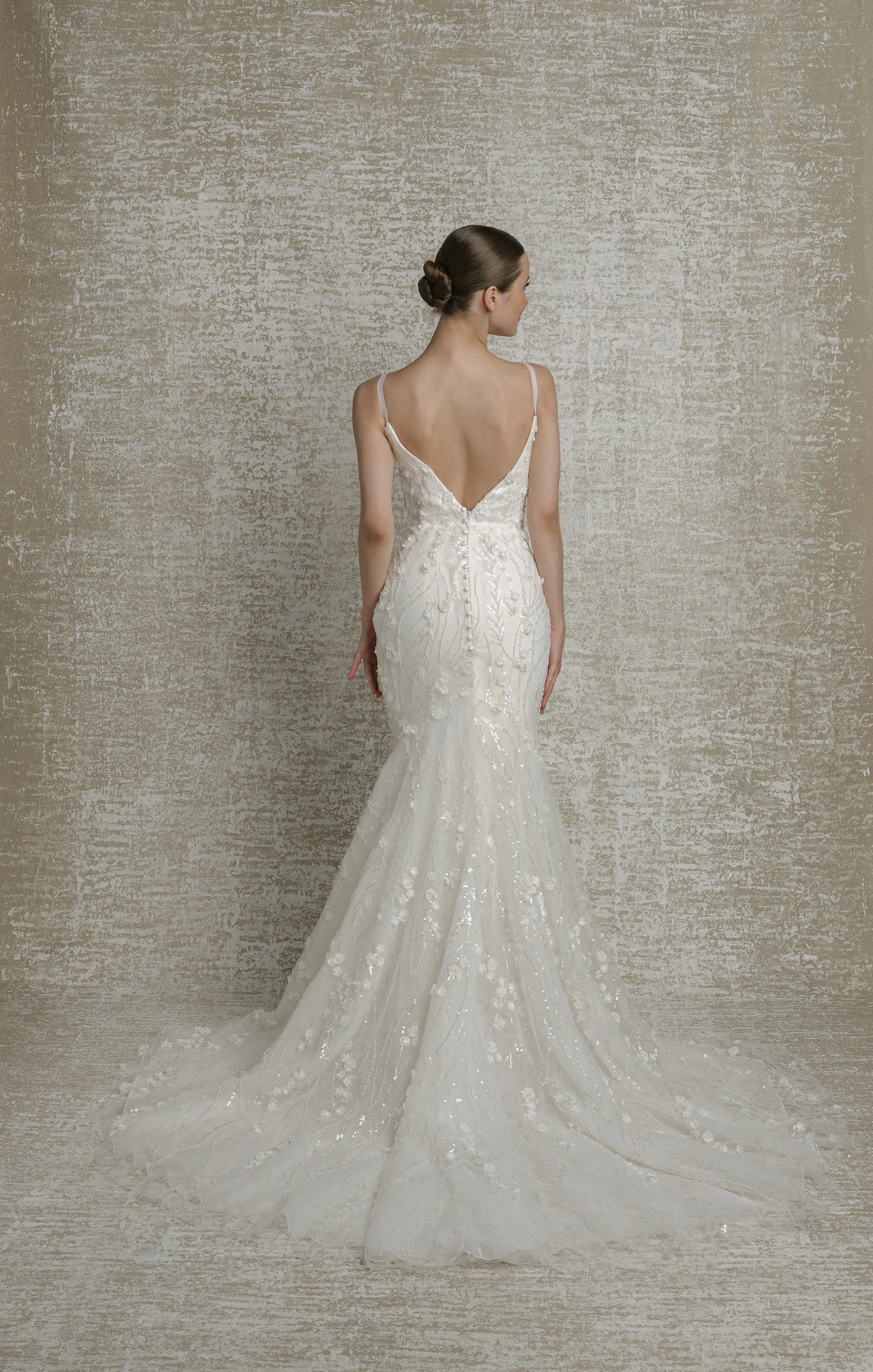 All over beaded 3D floral trailing sequinned lace, deep V neckline, thin straps, illusion cutouts under arms, fit to flare, low V back, zip closure with decorative buttons, chapel train.