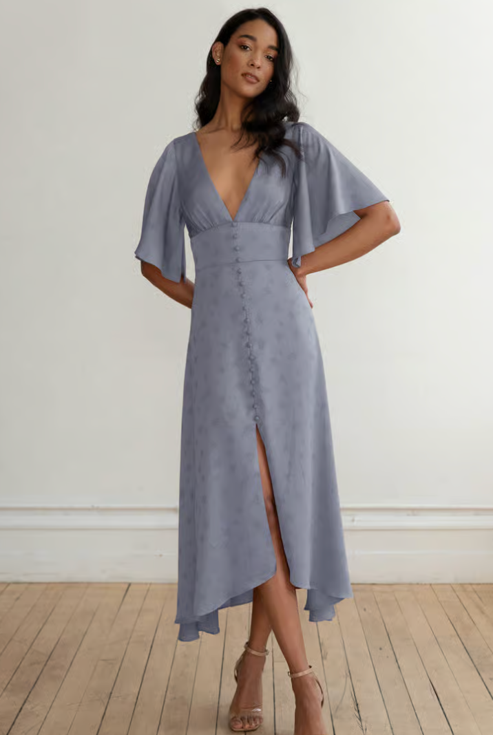 Woman wearing a blue dress with a plain background