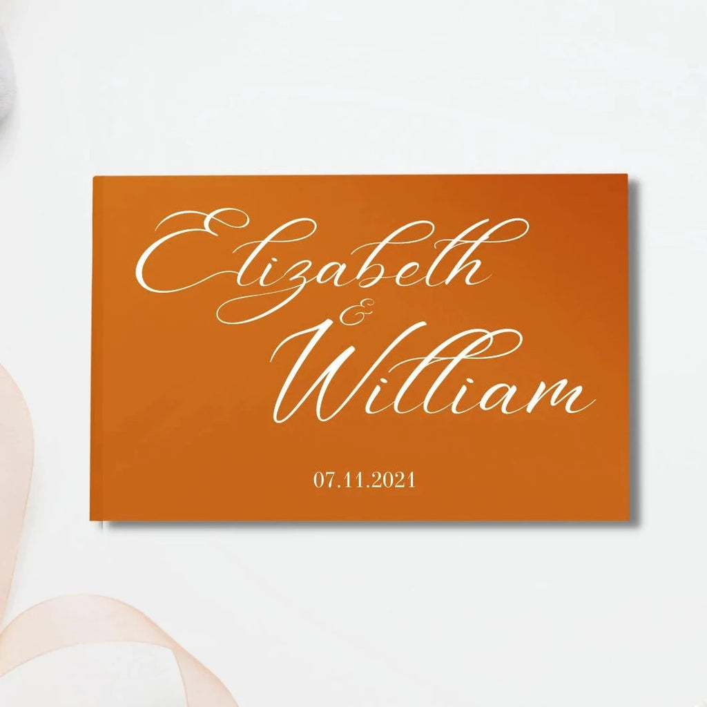 Orange guestbook with"Elizabeth & William 07.11.2021"written in white calligraphy