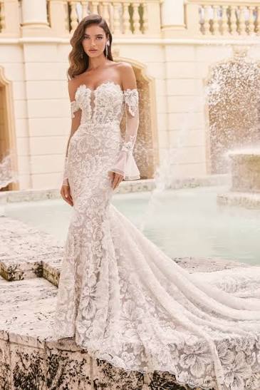 Spencer by Martin Thornburg is a fitted glitter tulle and unique lace fit and flare wedding dress available at NKIN
