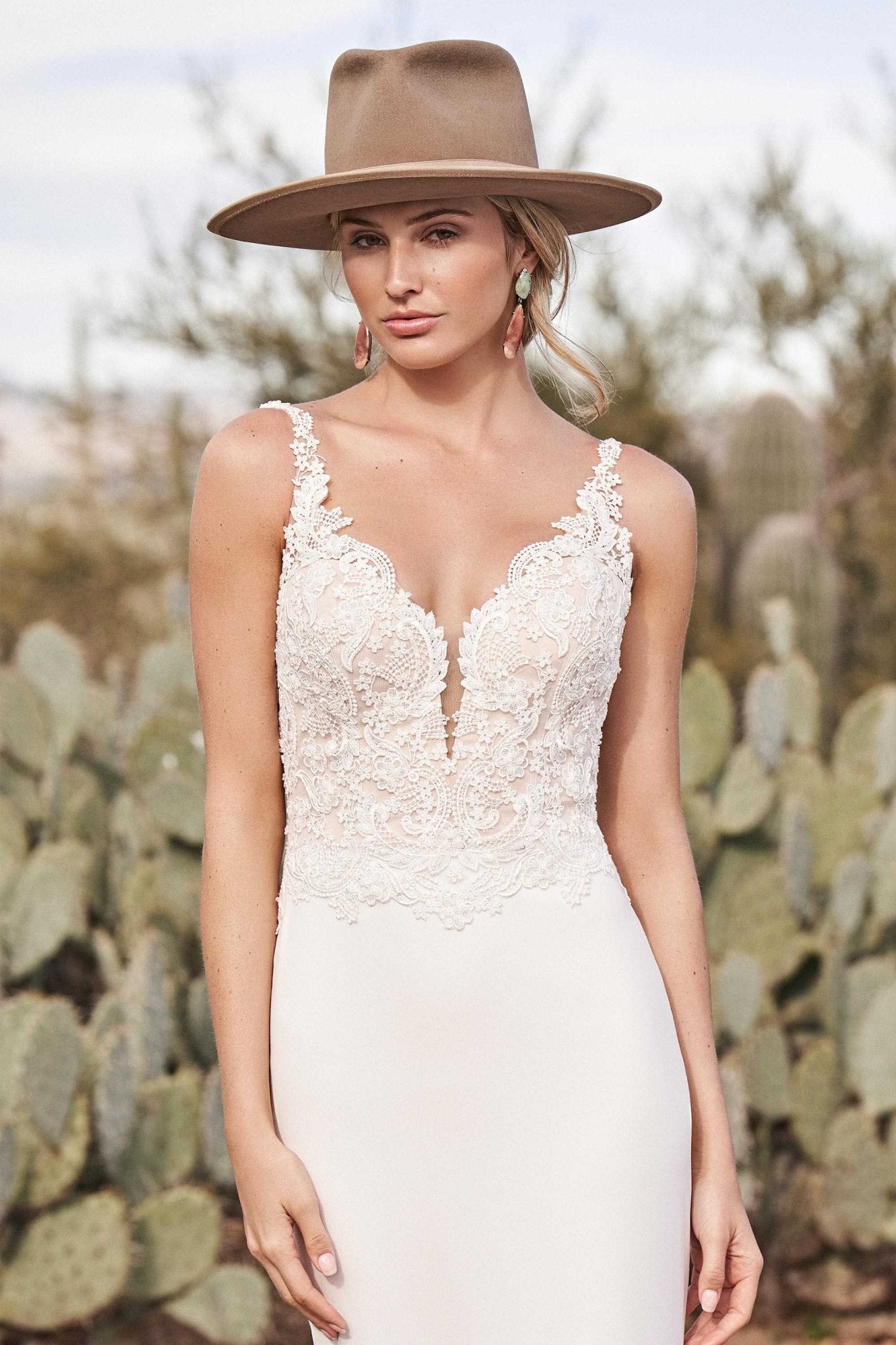 Woman wearing a fitted wedding dress with a lace beaded top close up view