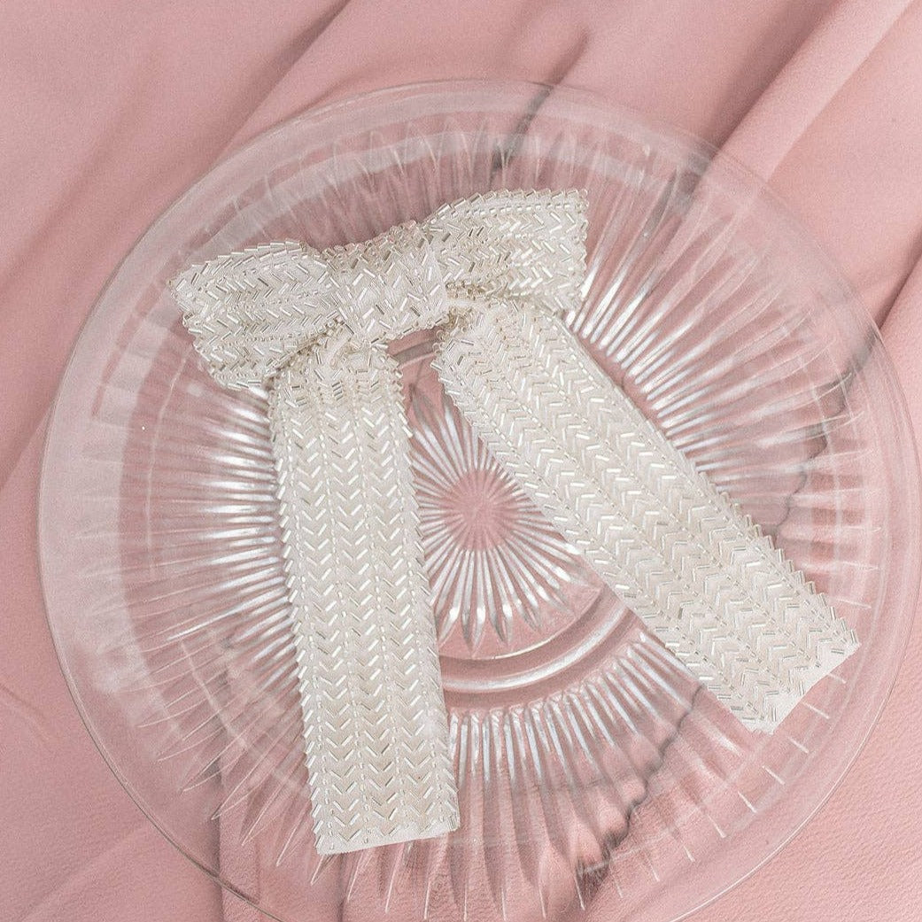 Flat lay of an ivory beaded bow