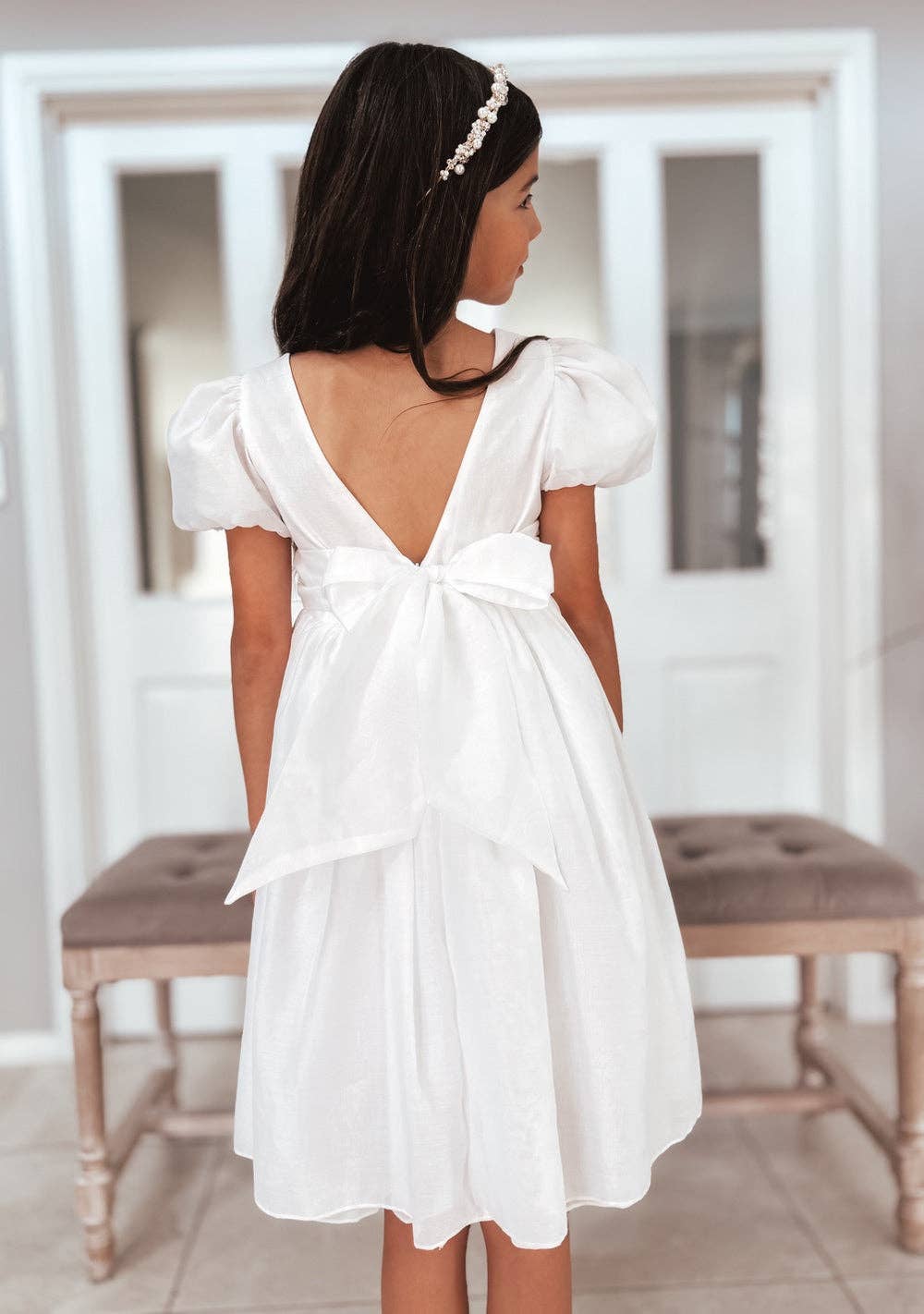 Full body back view of The "Delia" - Bow Dress