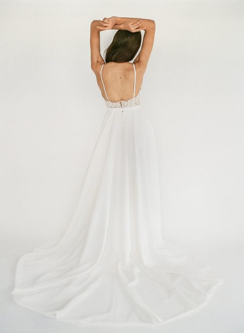 Trisha - an a-line white wedding dress with spaghetti straps and a lace v-neck bodice - full body back view