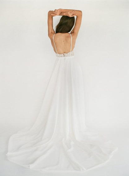 Trisha - an a-line white wedding dress with spaghetti straps and a lace v-neck bodice - full body back view