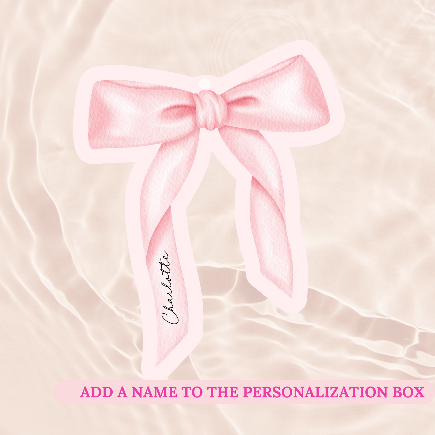 Pink bow with a name tag on a soft pink background