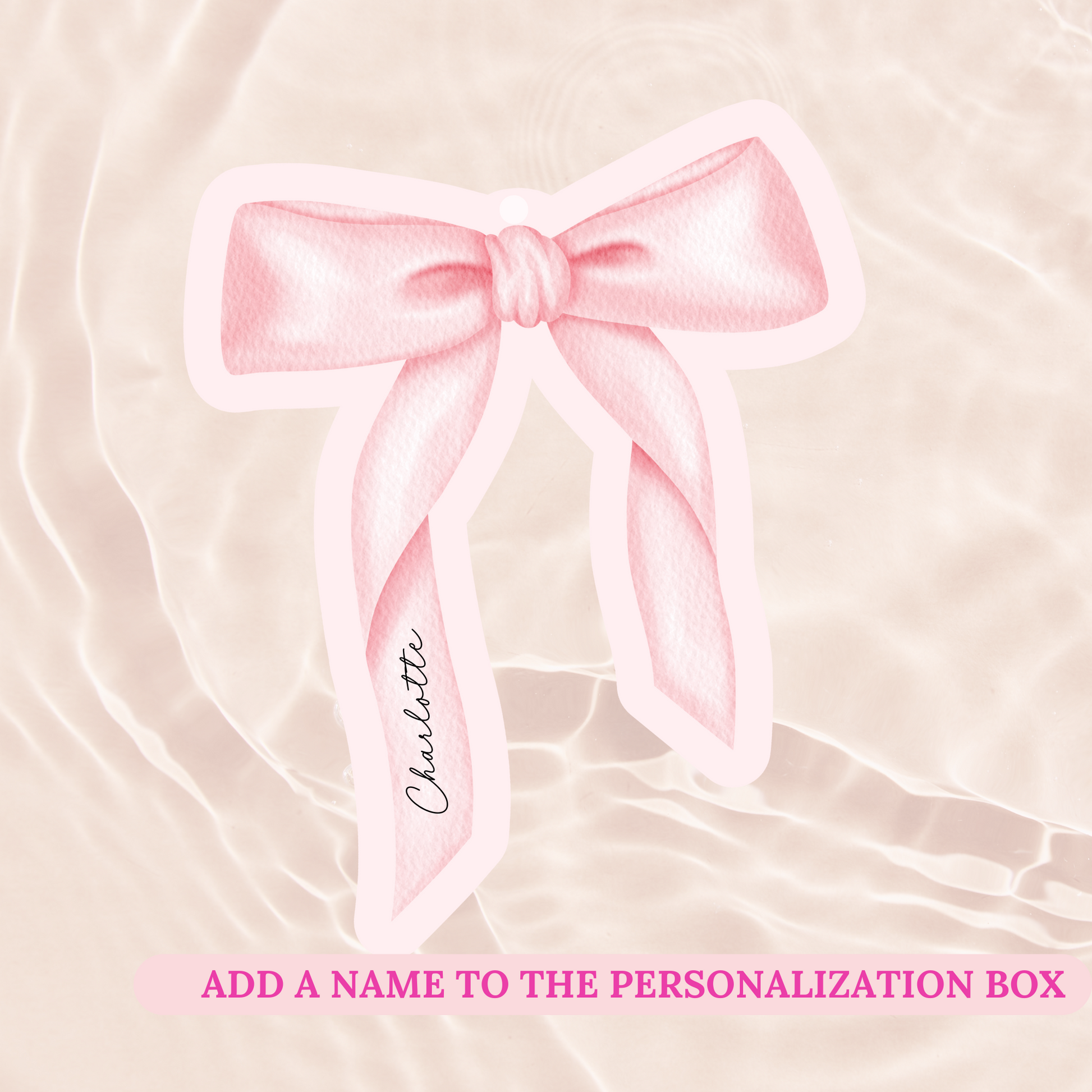 Pink bow with a name tag on a soft pink background