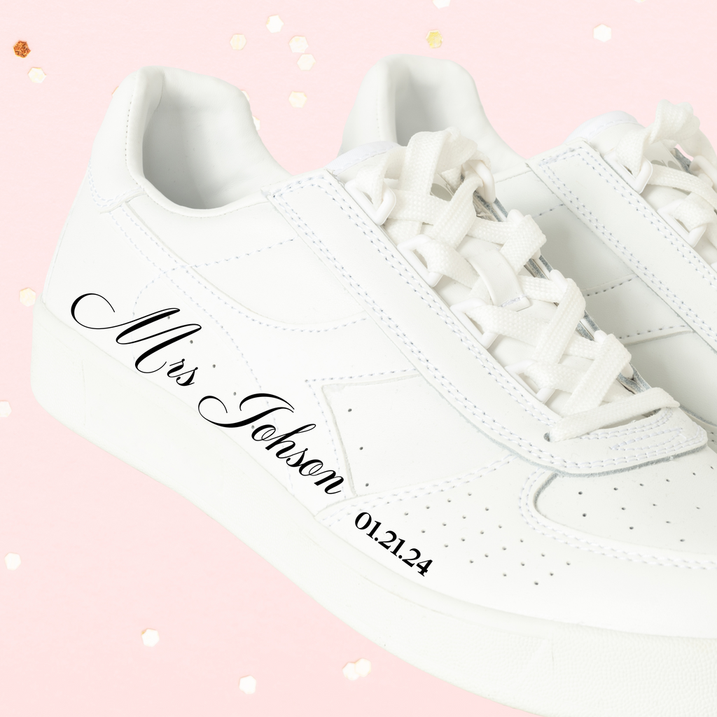 A white sneaker with "mrs johnson 01.21.24" ironed on in black