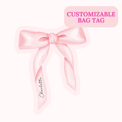 Pink customizable bag tag with a bow and the name 'Charlotte' on a white background