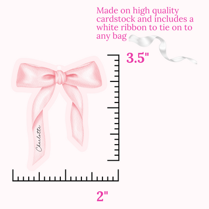 Pink bow with measurement details on a white background