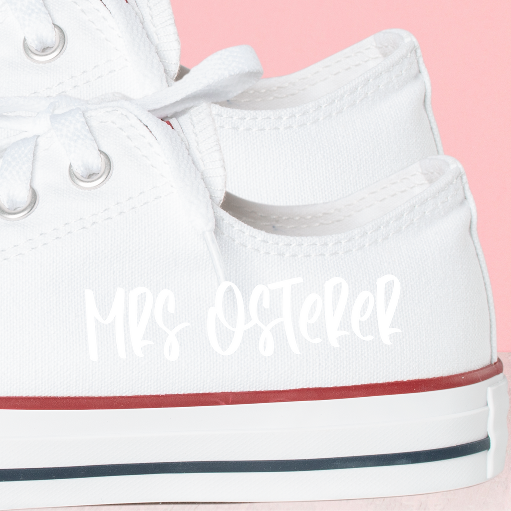 A white converse with "mrs osterer" written in white font