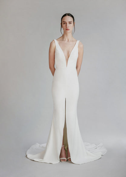 A gorgeous simple v-neck fit and flare gown, with a centre front slit and deep V back- full body front view
