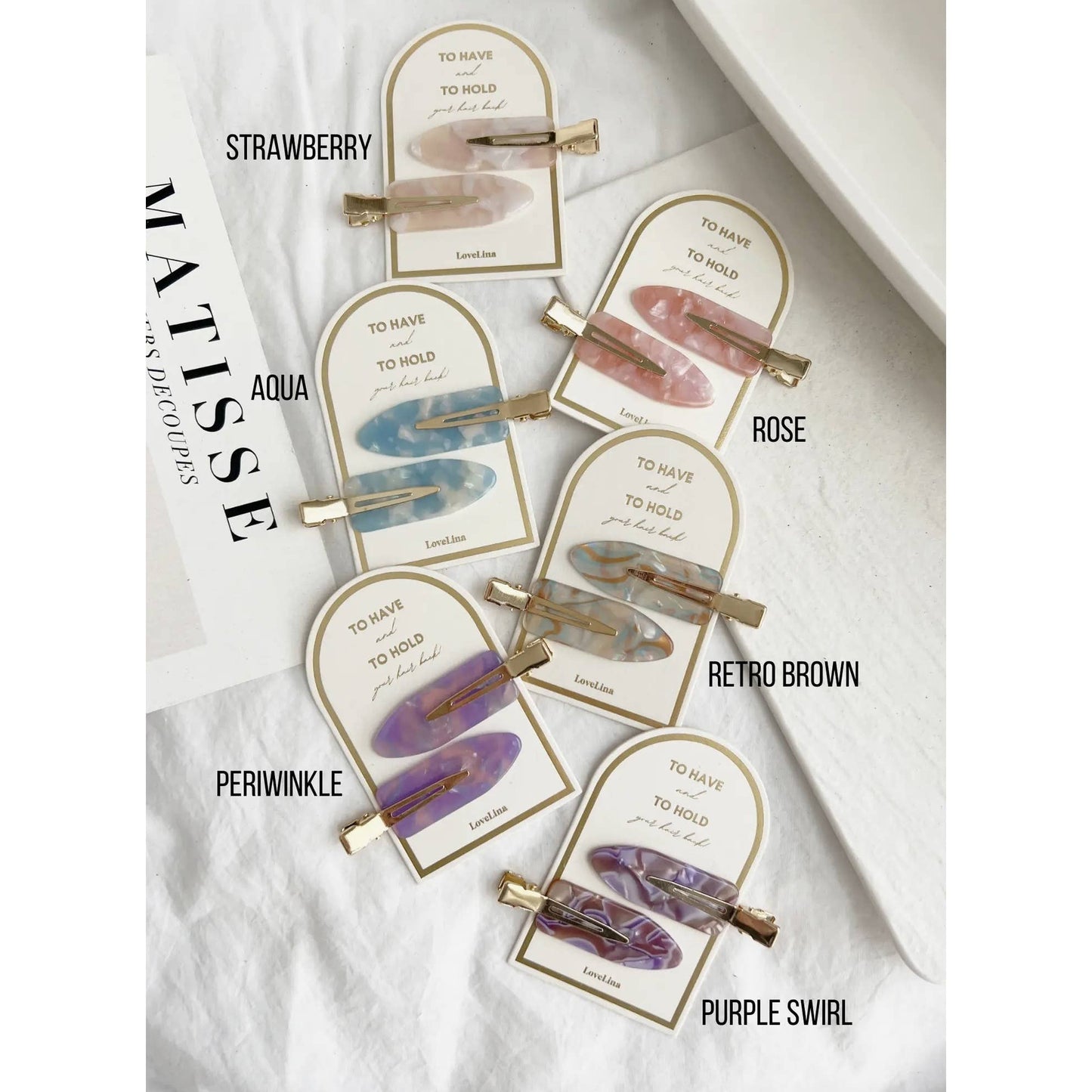 Crease free hair clips ona. gold and white backing that says "To Have and To Hold Your Hair Back"