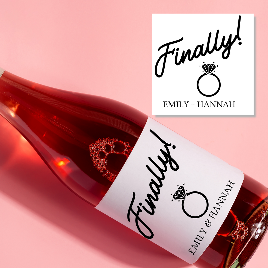 A rose wine bottle with "Finally! Emily & Hannah" written on the label
