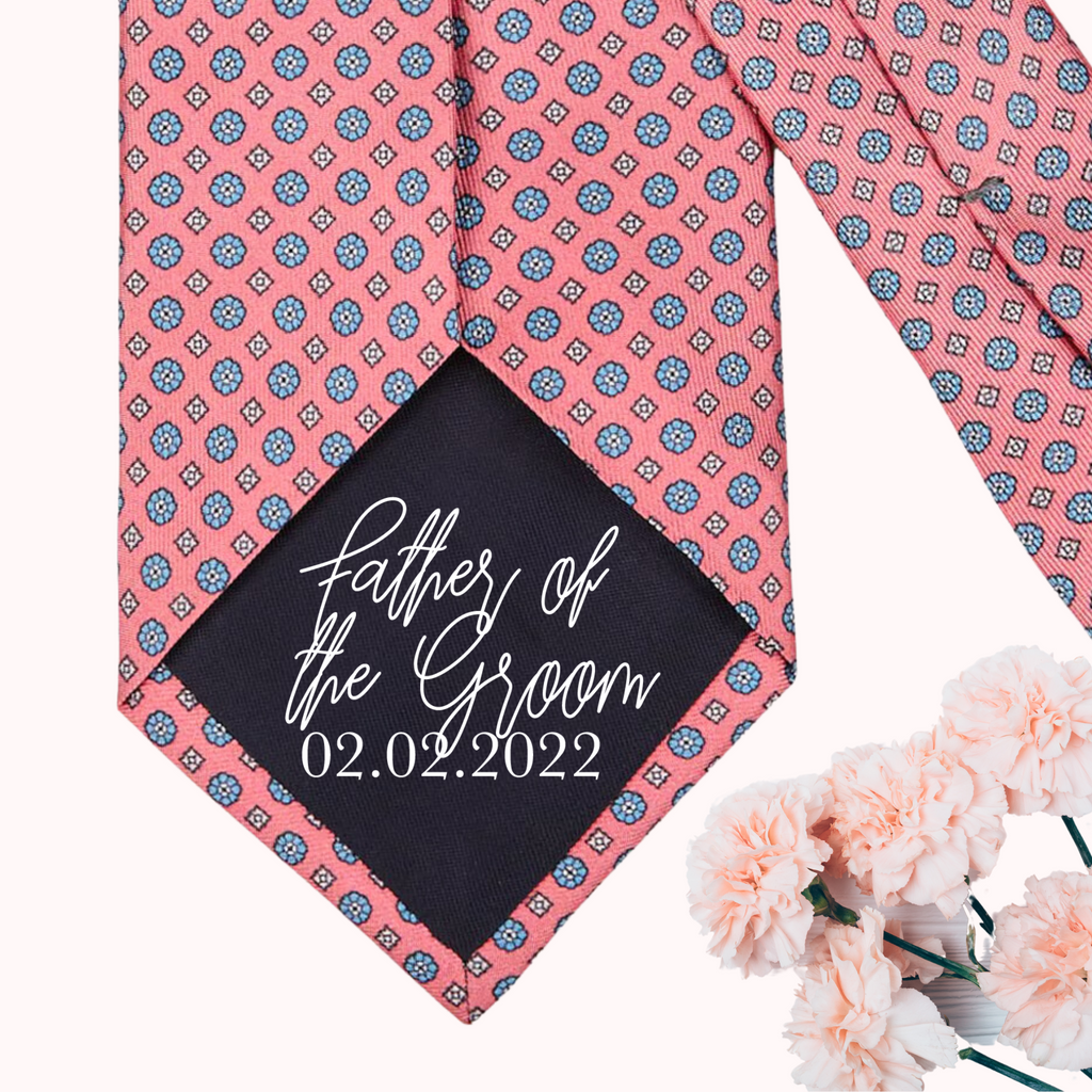 "Father of the groom 02.02.2022" written in whtie on a pink and blue tie aptch