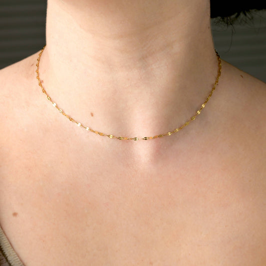 young woman wearing the gold minimalist choker