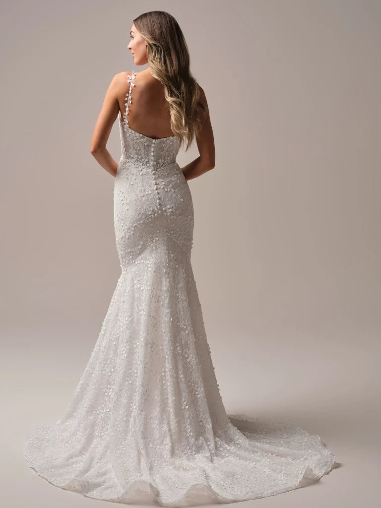 Wedding Dresses | The Isabella wedding gown, available in our curvy fit, is designed to celebrate your shape with confidence and elegance. This flattering fit-and-flare silhouette hugs in all the right places, while delicate floral lace cascades from bodice to hem for a romantic finish. A plunging neckline with illusion straps adds modern allure, and the button-back detail with a flowing train ensures you’ll turn heads from every angle. Perfect for the bride who wants classic beauty with a contemporary twis