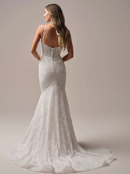 Wedding Dresses | The Isabella wedding gown, available in our curvy fit, is designed to celebrate your shape with confidence and elegance. This flattering fit-and-flare silhouette hugs in all the right places, while delicate floral lace cascades from bodice to hem for a romantic finish. A plunging neckline with illusion straps adds modern allure, and the button-back detail with a flowing train ensures you’ll turn heads from every angle. Perfect for the bride who wants classic beauty with a contemporary twis