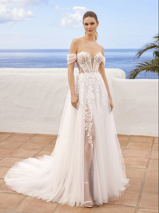 Leaving us in a trance, CLAIRE is perfect for our dreamy romantics. This ethereal A-line beauty showcases a plunging sweetheart neckline with intricate 3D floral motifs and embroidered lace atop sparkly glitter tulle fabric. The romantic exposed corset boning, illusion side cut-outs, and off-the-shoulder tulle straps tie together to create an enchanting bridal look. The lovely lace is carefully placed along the corset-style back and peek-a-boo slit, trickling down into a soft and sparkly tulle skirt.

