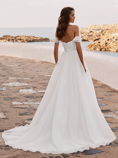 Introducing the DAISIE gown, crafted from delicate organza fabric with a draped bodice that accentuates your silhouette. Its off-the-shoulder straps exude timeless romance, framing your shoulders with elegance. The sweetheart neckline adds a touch of classic allure.

