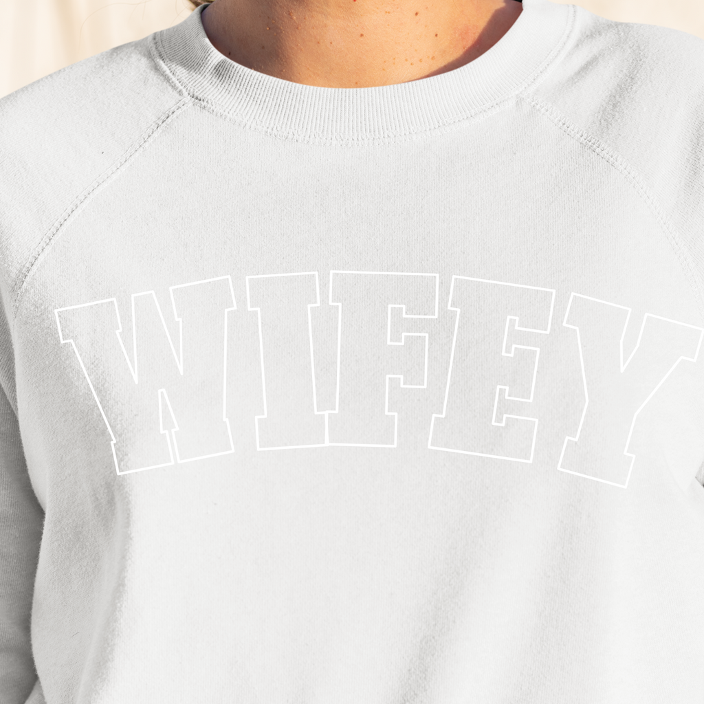 A white sweater with "wifey" written in big block letters