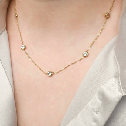 Bezel necklace on a woman's neck