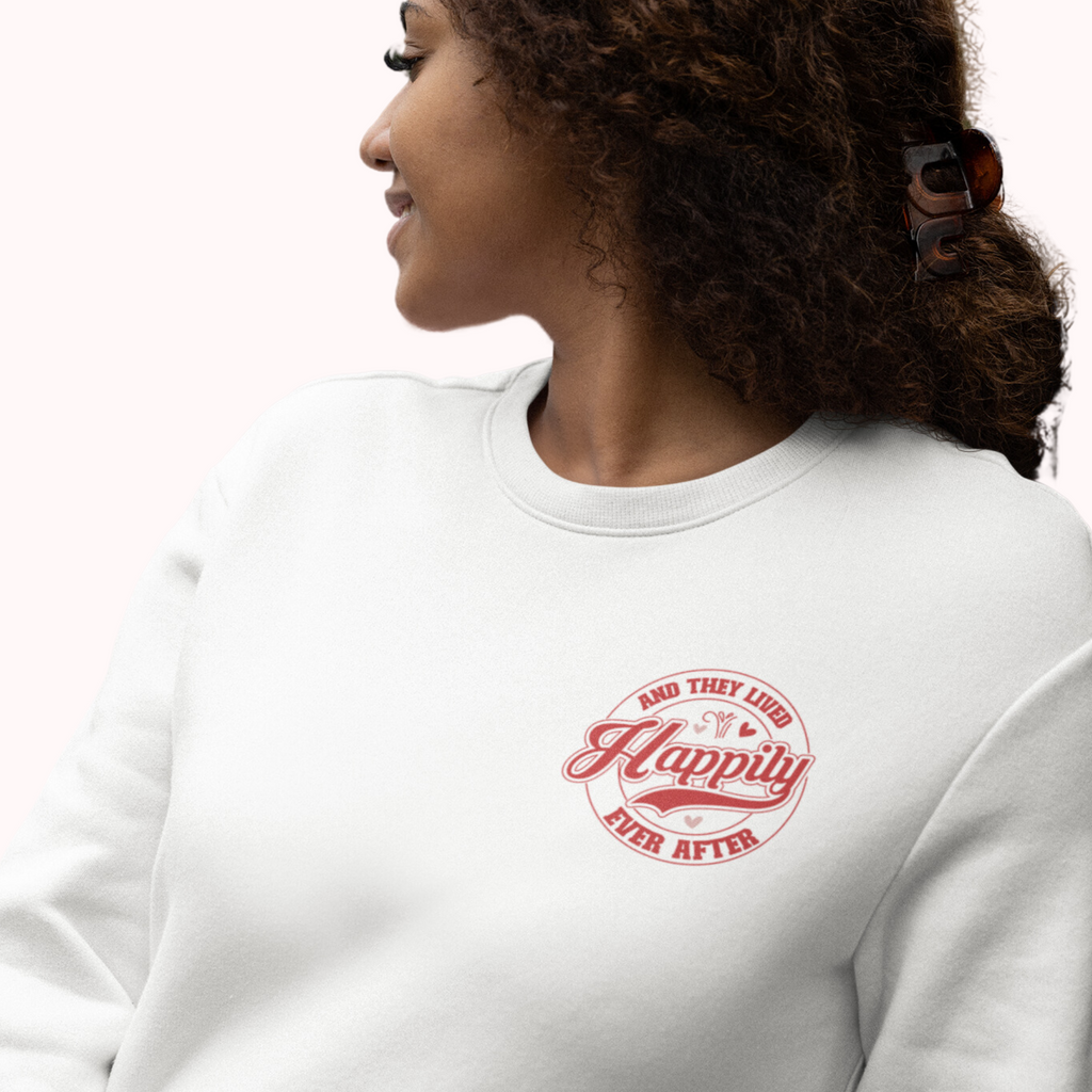Woman wearing a white crewneck with "and they lived happily ever after" in red