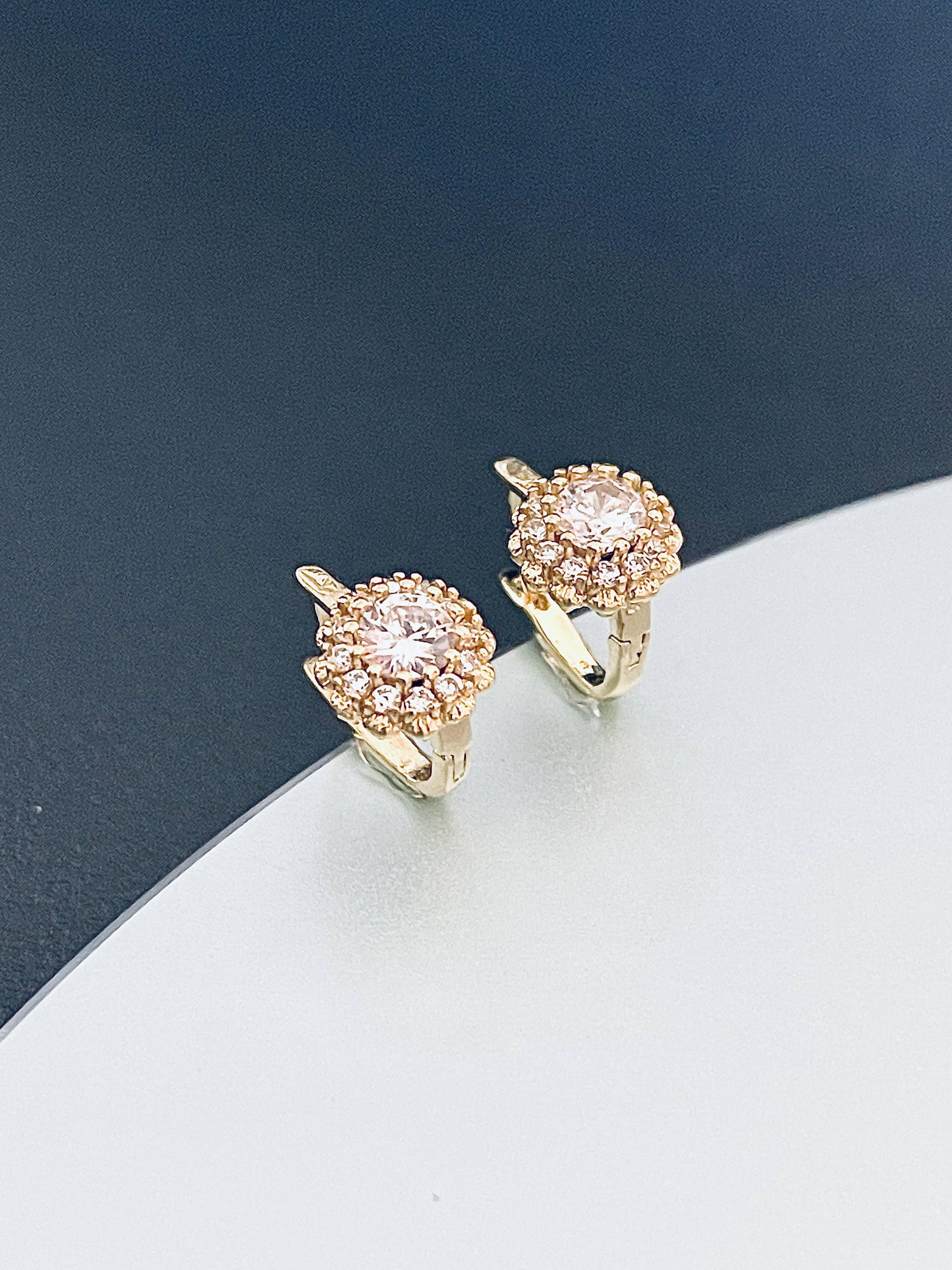 Small gold earrings with a floral shape
