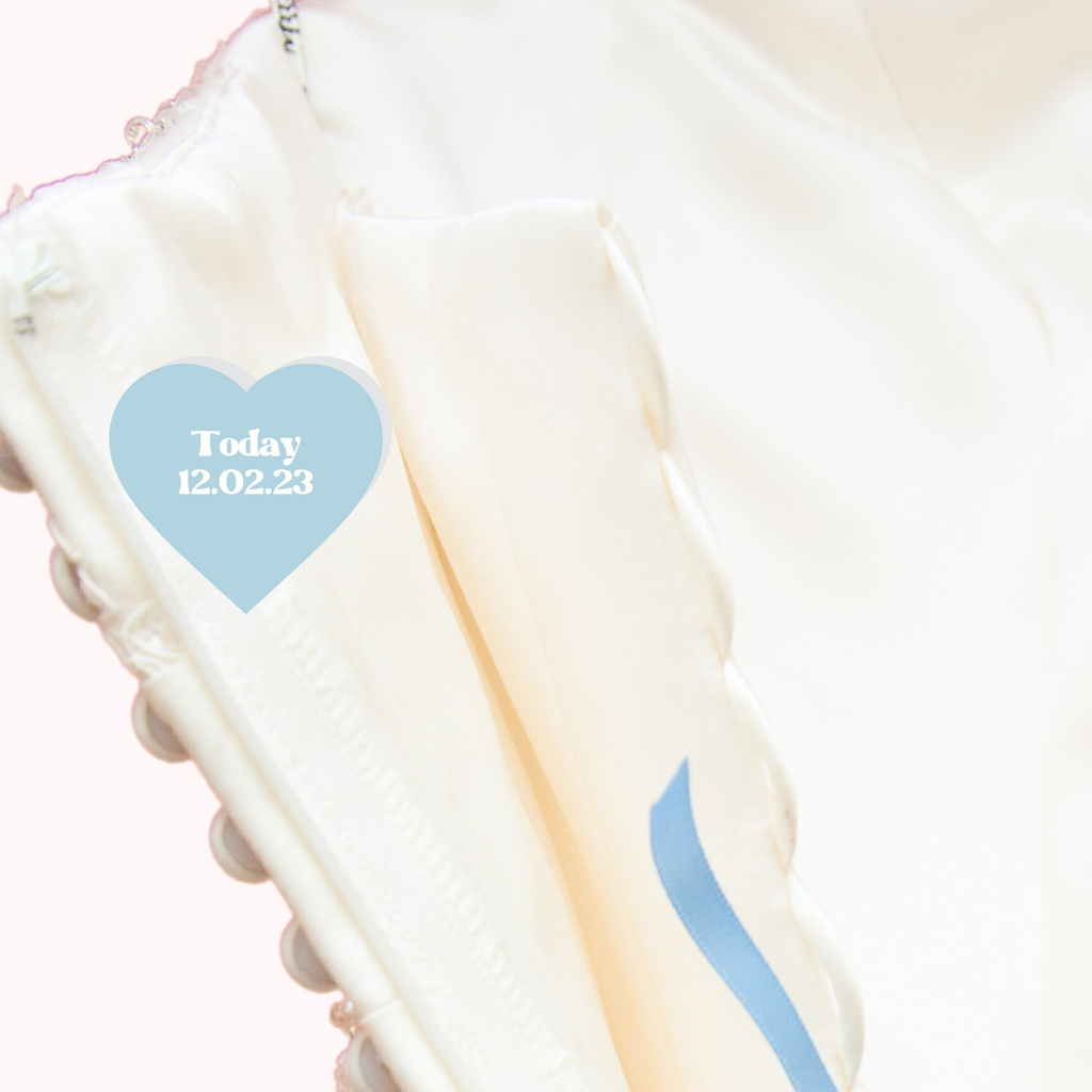 Heart iron on patch in blue with "today 12.02.23" written in white on the wedding dress