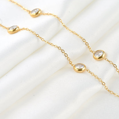Bezel necklace laying on a white sheet