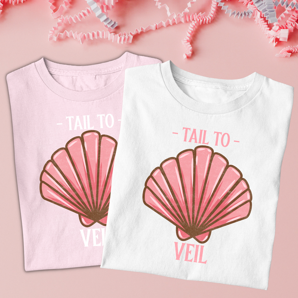 A white and pink shirt with "tail to veil" written with a seashell