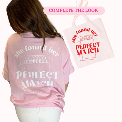 Pink t-shirt with 'she found her PERFECT MATCH' text and matching tote bag on a white background.