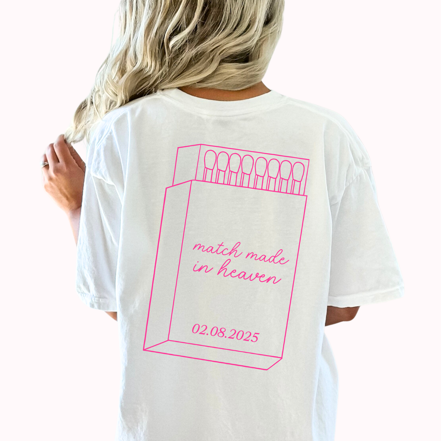 White t-shirt with pink graphic and text on a white background