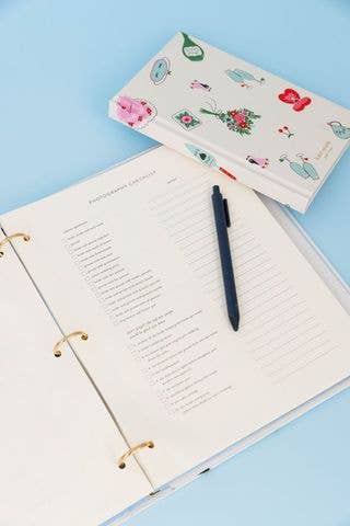 White kate spade planner with small wedding graphics inside pages