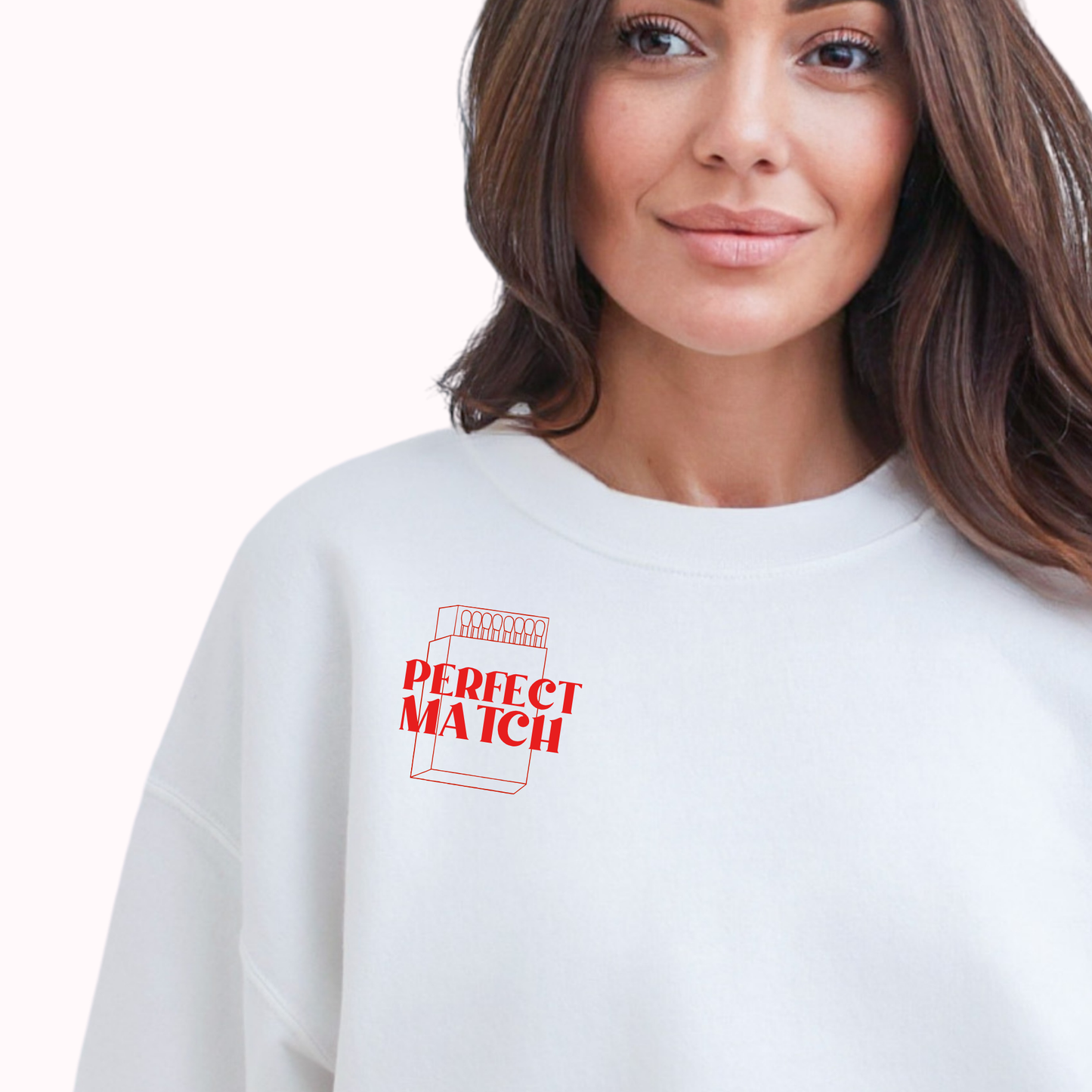 Woman wearing a white sweatshirt with 'Perfect Match' text and design.