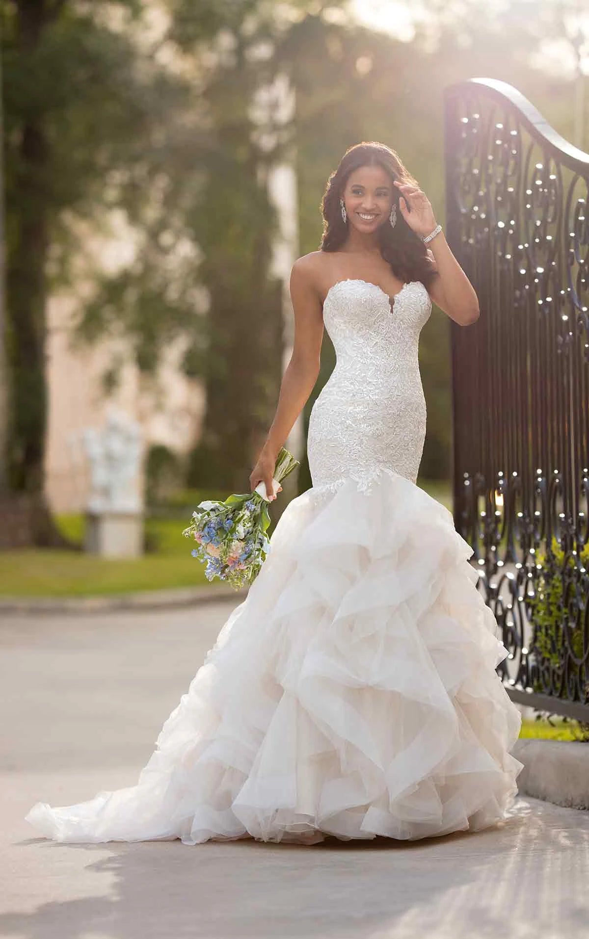 Young woman wearing a large mermaid lace and beaded wedding dress