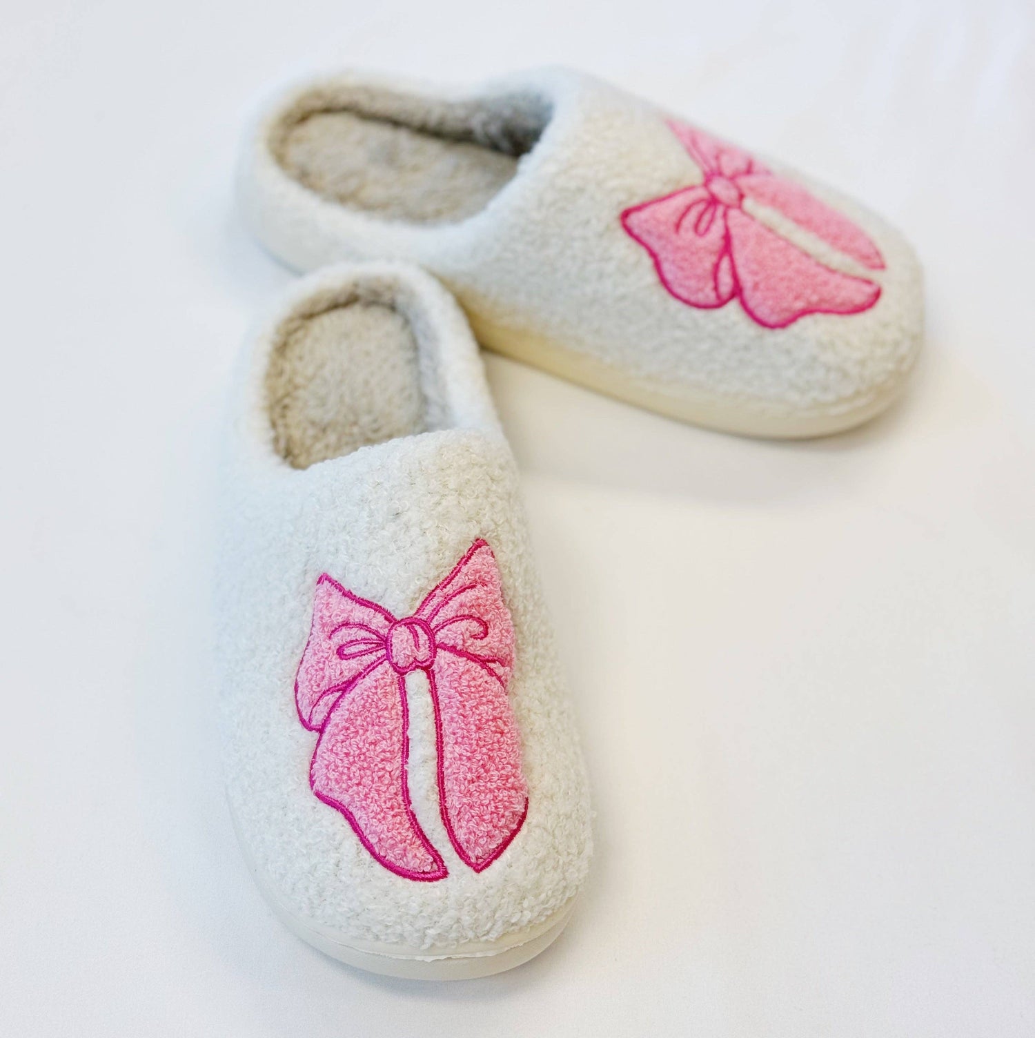 White slippers with a pink bow