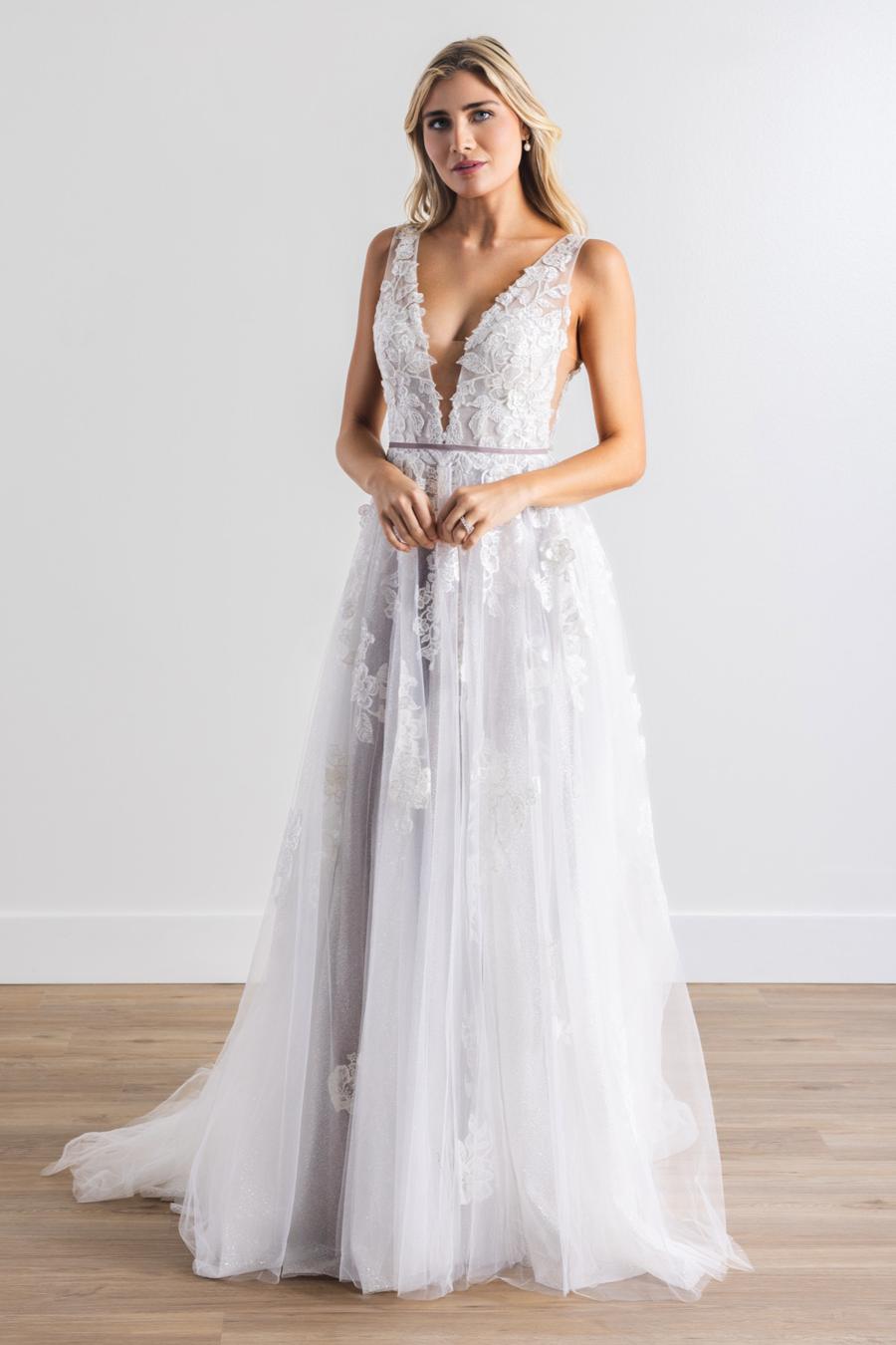 Floral Appliques layered with sparkle tulle and soft lavender tones. Juliana's V neckline and A-line romantic skirt are a bridal match made in heaven. Finally, this gown is finished with a removeable velvet ribbon belt.