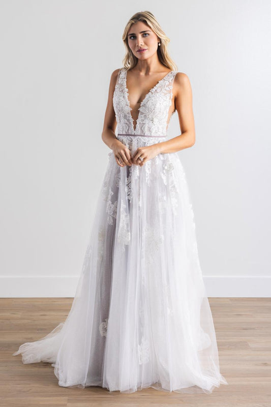 Floral Appliques layered with sparkle tulle and soft lavender tones. Juliana's V neckline and A-line romantic skirt are a bridal match made in heaven. Finally, this gown is finished with a removeable velvet ribbon belt.