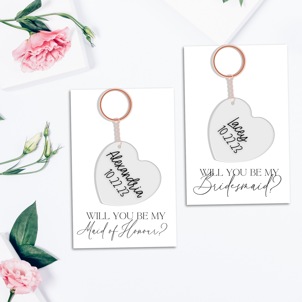 2 custom key chains in hearts with alexandria and lacey written on them with custom proposal cards