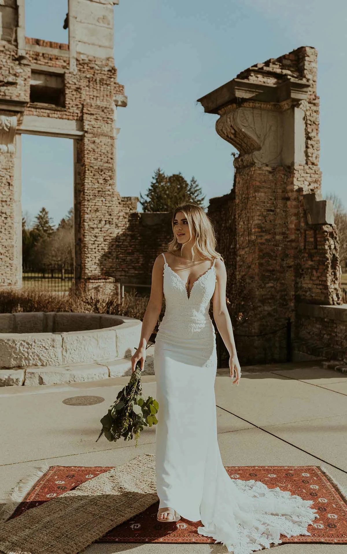 Woman wearing a long lace fitted wedding dress front view