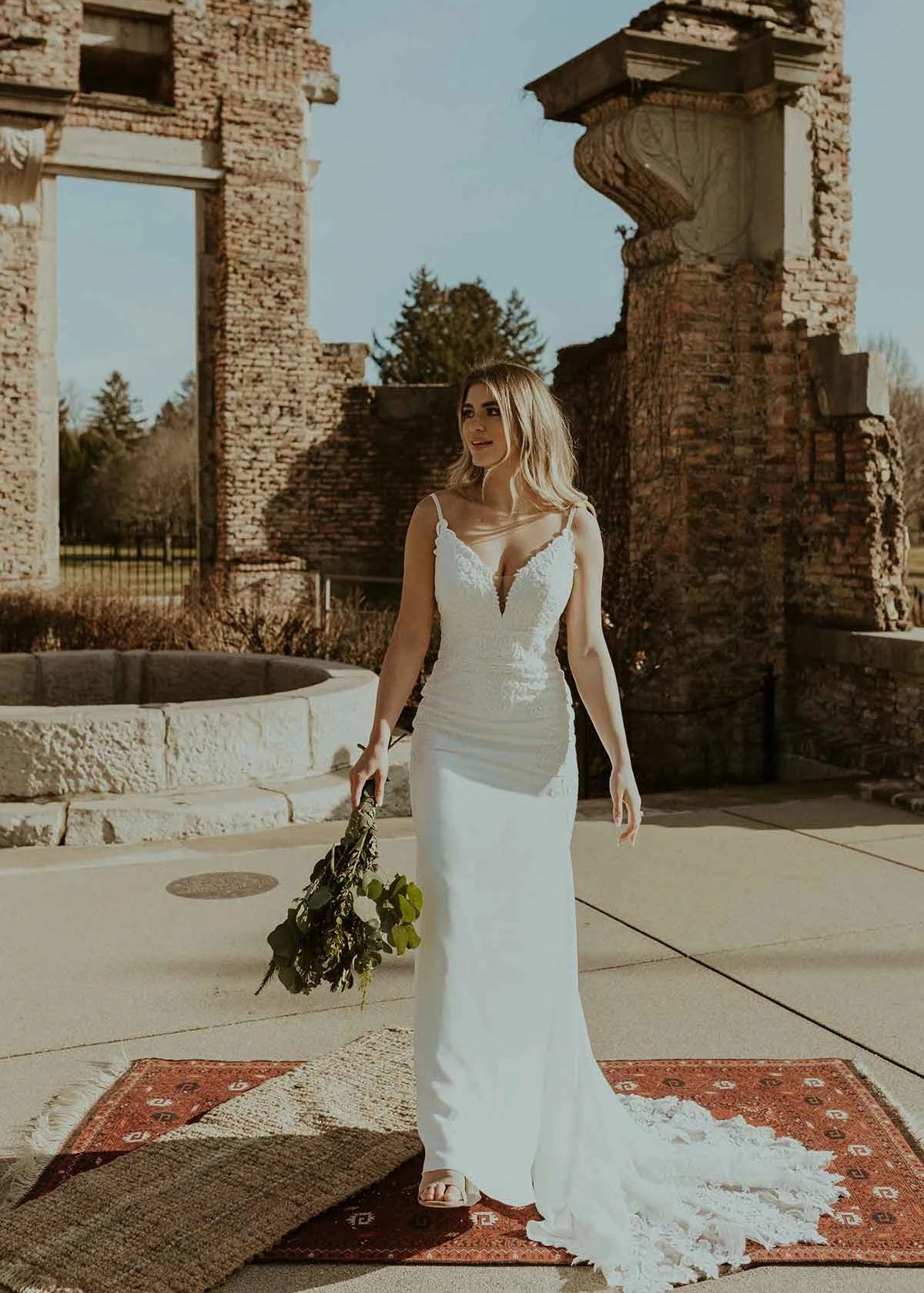 Woman wearing a long lace fitted wedding dress front view