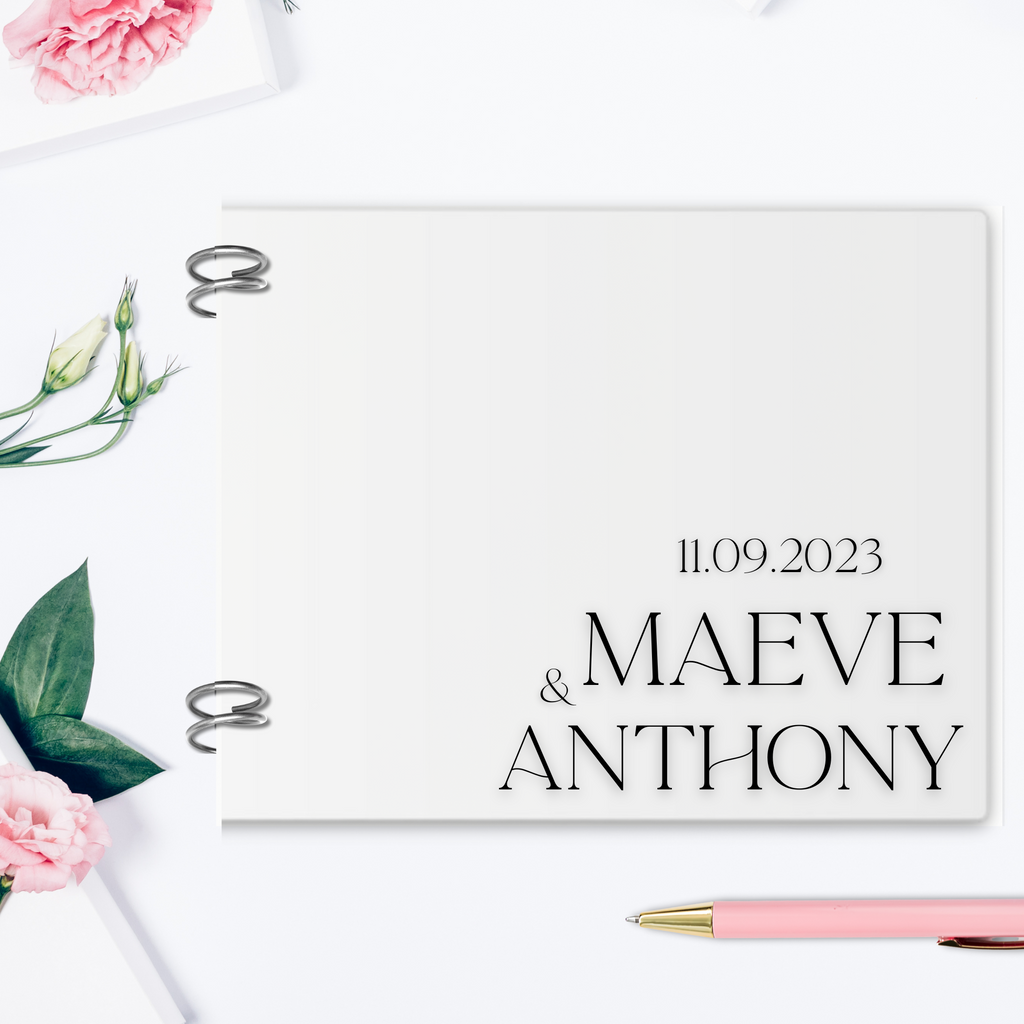 An acrylic guest book, with "Maeve & Anthony, 11.09.2023" printed on in vinyl