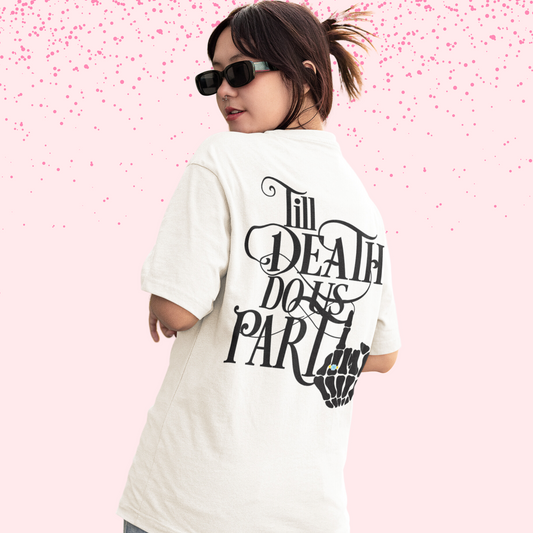 Woman wearing white shirt with "till death do us part" written in black with a diamond ring