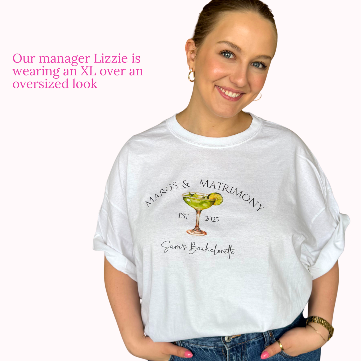 Woman wearing a white t-shirt with a graphic design and text, standing against a plain background.